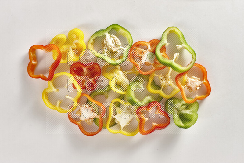 Assorted bell pepper slices on white background