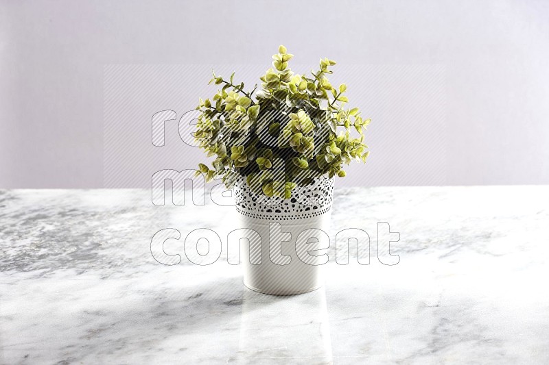 Artificial Plant in White Decorative Pot on Light Grey Marble Background 45 degree angle