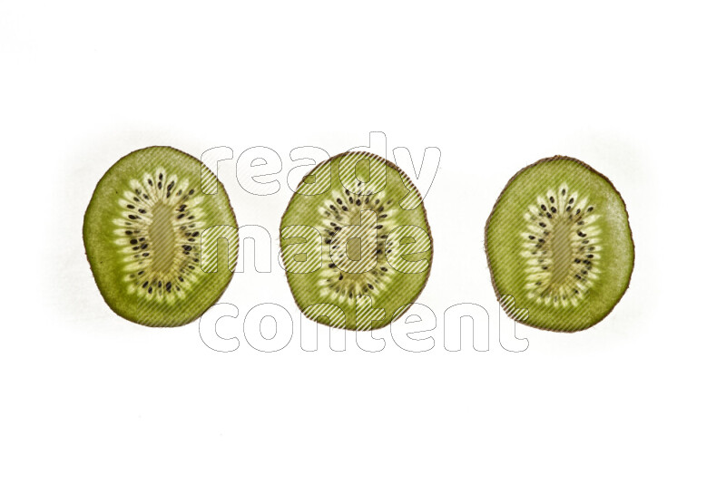 Kiwi slices on illuminated white background
