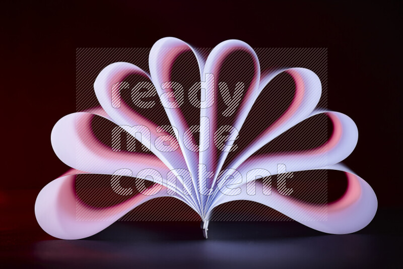 An abstract art piece displaying smooth curves in pink and purple gradients created by colored light
