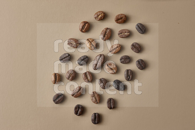 Roasted coffee beans on beige background