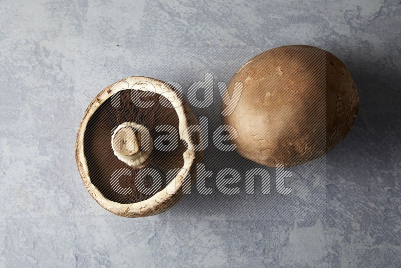 Fresh portobello mushrooms topview  on a light blue background