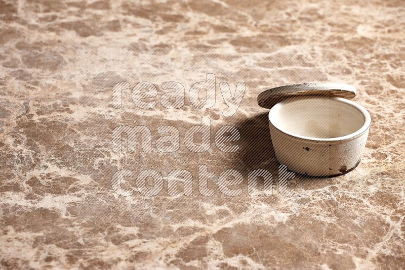 White Pottery Bowl on Beige Marble Flooring, 45 degrees