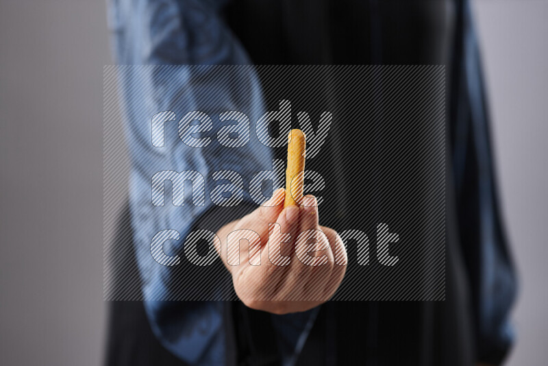Woman in abaya holding different kinds of snacks in different positions