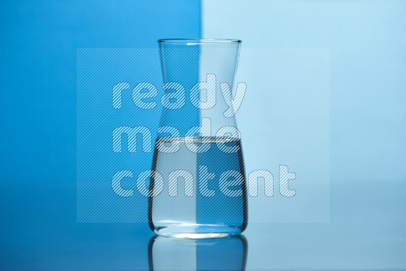 The image features a clear glassware filled with water, set against blue and light blue background