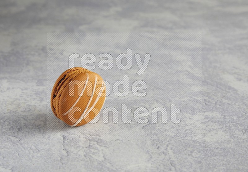 45º Shot of Brown Irish Cream macaron on white marble background