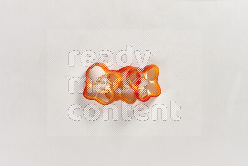 Red bell pepper slices on white background