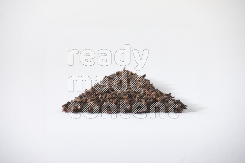 cloves in a triangle shape on a white flooring