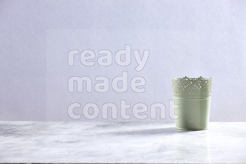 An Empty Light Green Plant Pot on light grey Marble Flooring 15 degree angle