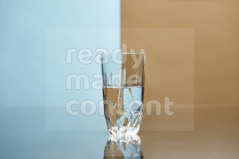 The image features a clear glassware filled with water, set against light blue and beige background