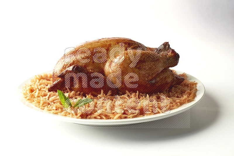 red basmati Rice with  whole roasted chicken on a white rounded plate  direct  on white background