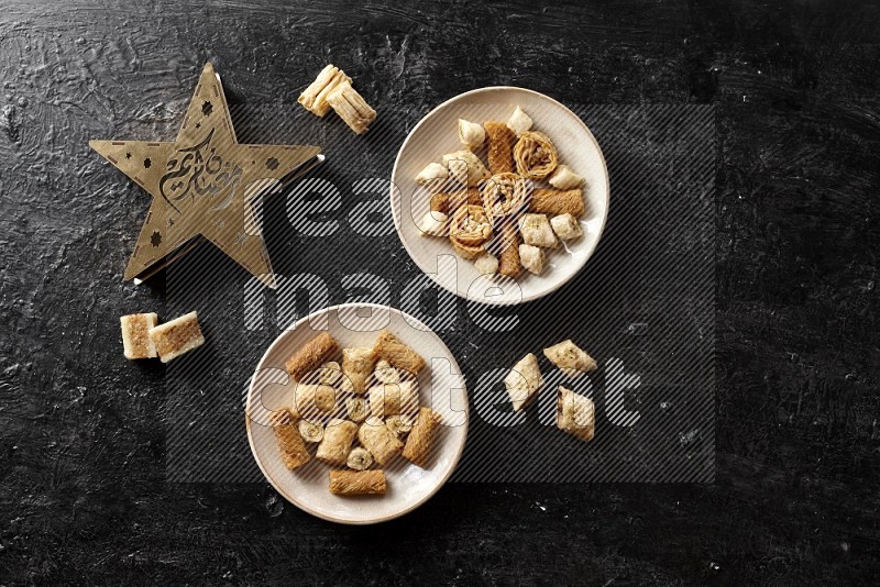 Oriental sweets in pottery plates with a lantern in a dark setup
