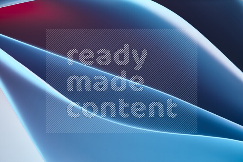 هذه الصورة تعرض تكوين فن الورق التجريدي مع منحنيات ورقية بتدرجات اللون الأزرق والأحمر المكونه بواسطة الضوء الملون