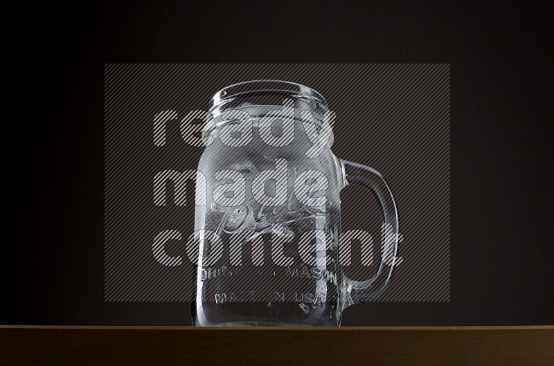Low angle shot of a jar of water and ice on grey background