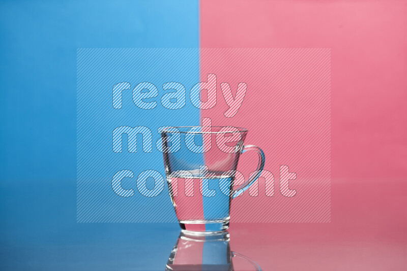 The image features a clear glassware filled with water, set against blue and pink background