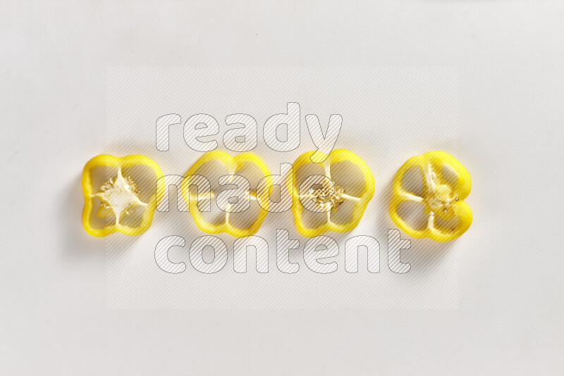 Yellow bell pepper slices on white background