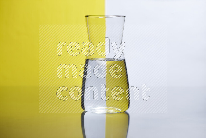 The image features a clear glassware filled with water, set against white and yellow background