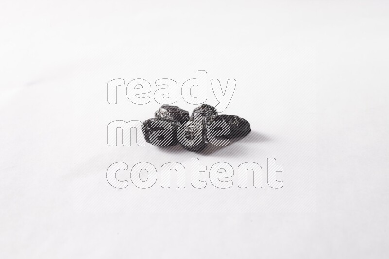 Dried plums on white background