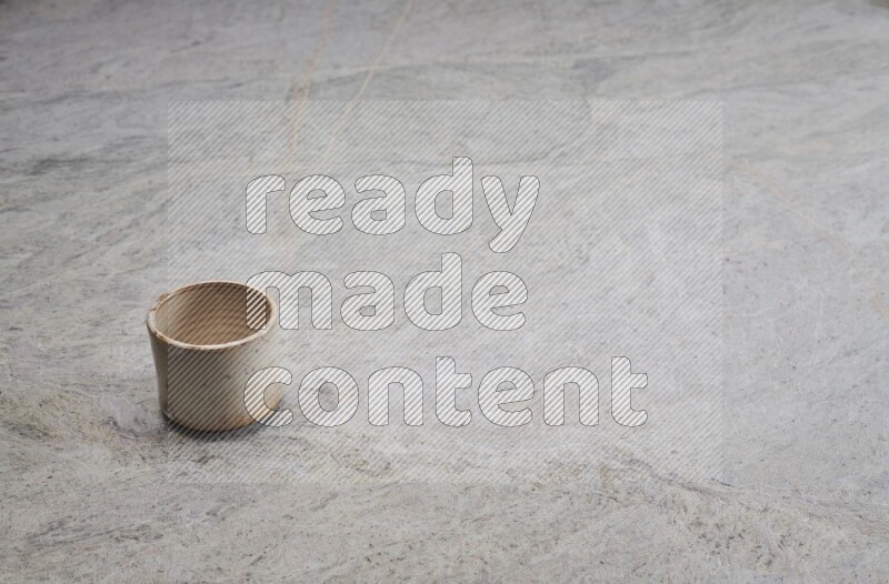 A multicolored pottery Cup on grey marble background