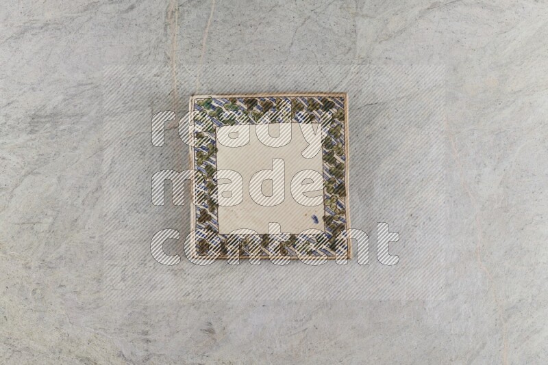 A decorative pottery plate on grey marble background