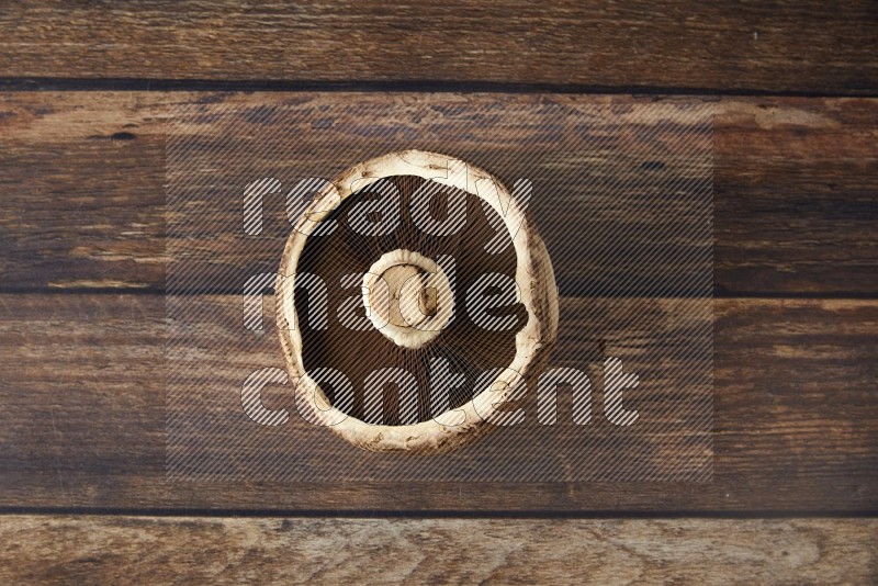 Fresh portobello mushroom topview on a wooden textured background