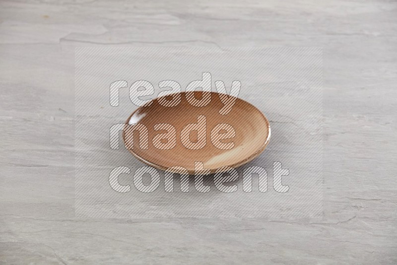 multi color ceramic round plate on grey textured countertop