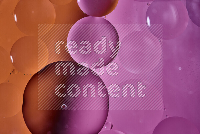 Close-ups of abstract oil bubbles on water surface in shades of orange and pink
