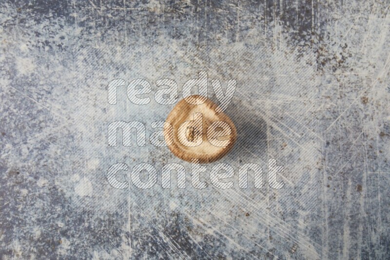 single fresh shiitake Mushroom topview  on a blue textured background