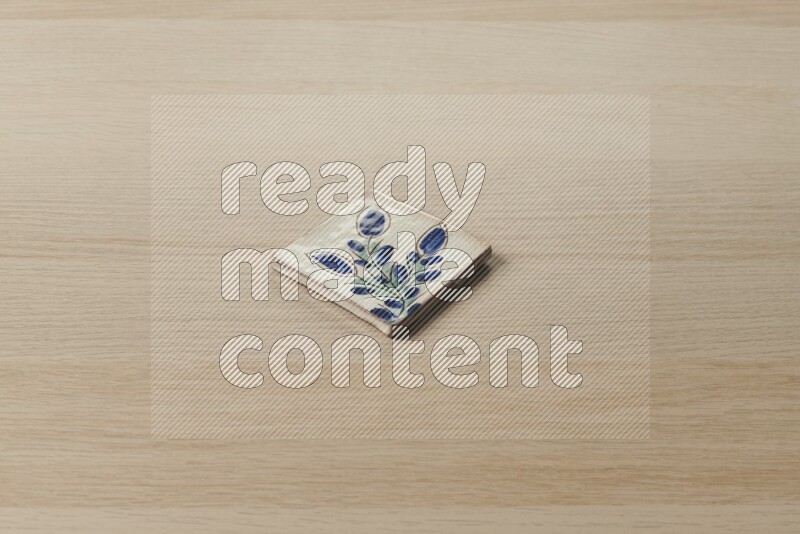 A decorative coaster on light wooden background