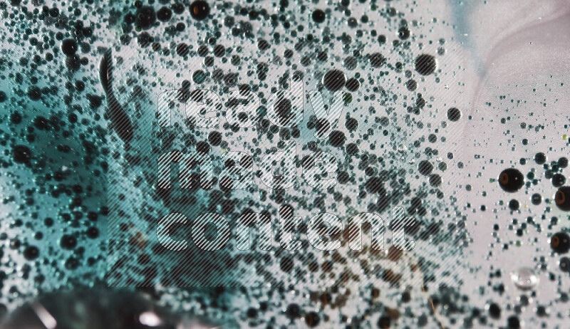 Close-ups of abstract green watercolor drops on oil Surface on white background