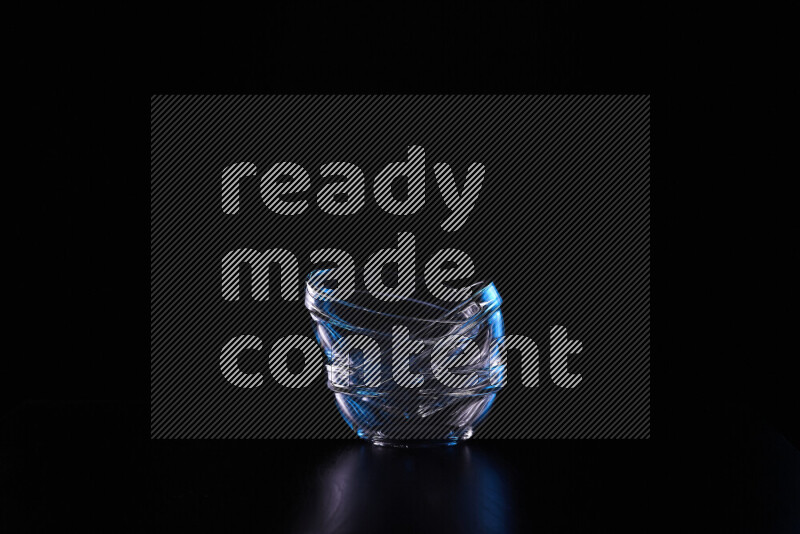 Glassware with rim light in blue and white against black background