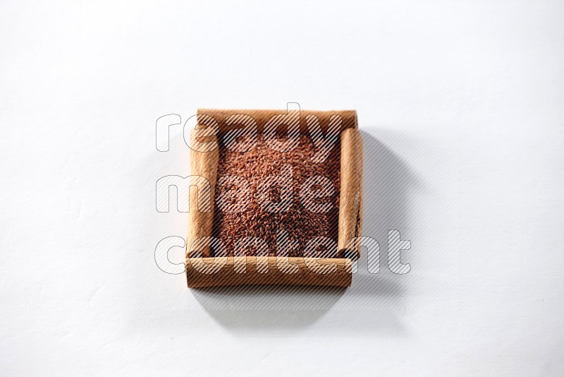 A single square of cinnamon sticks full of garden cress on white flooring