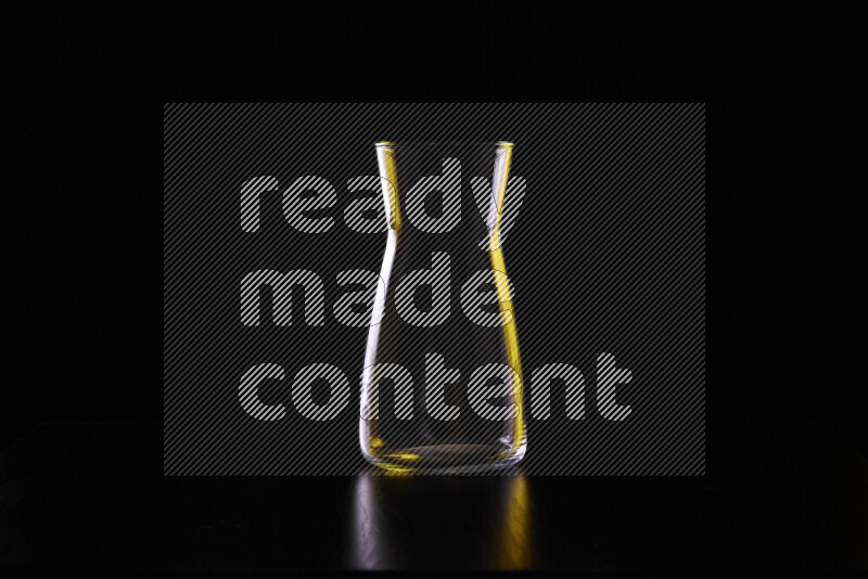 Glassware with rim light in yellow and white against black background