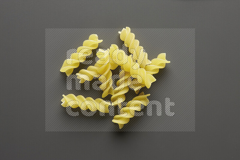Fusilli pasta on grey background
