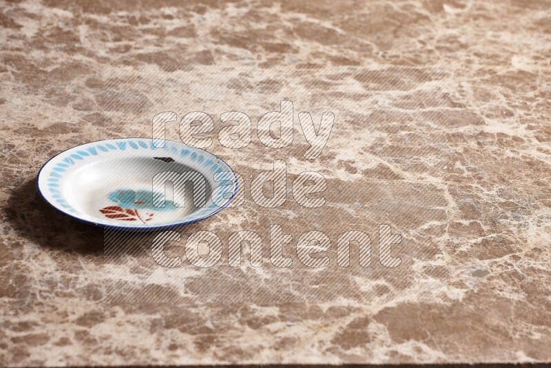 A vintage metal plate on beige marble background