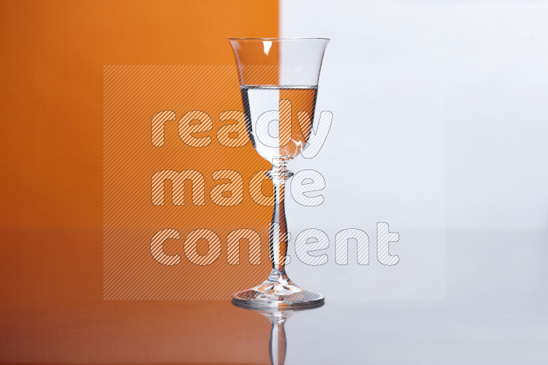 The image features a clear glassware filled with water, set against white and orange background