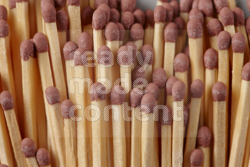 A close-up of a bundle of matches on grey background