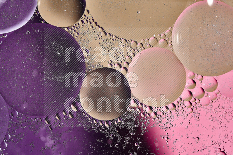 Close-ups of abstract oil bubbles on water surface in shades of brown, purple and pink