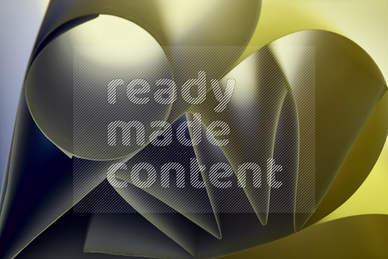 An artistic display of paper folds creating a harmonious blend of geometric shapes, highlighted by soft lighting in green tones