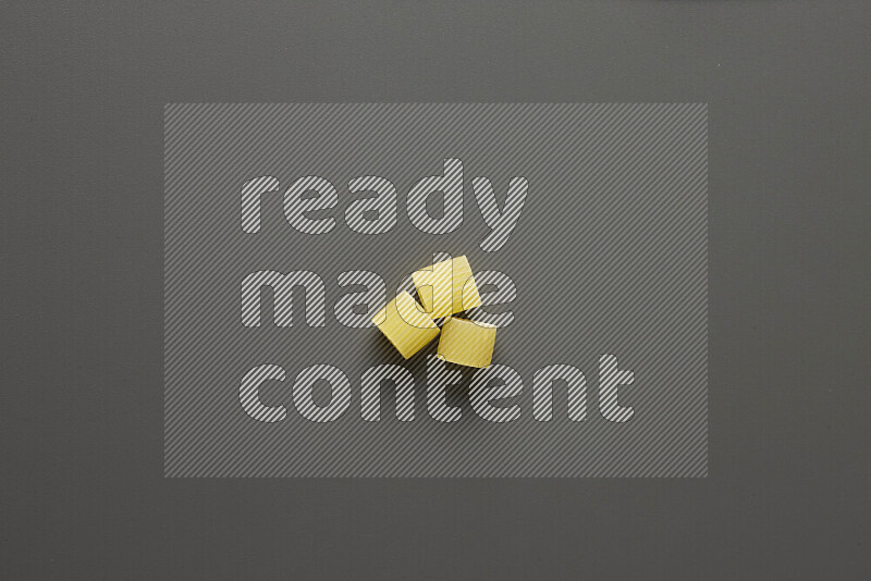 Big rings pasta on grey background