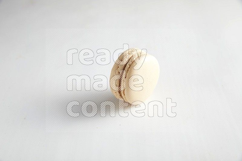 45º Shot of White Caramel fleur de sel macaron on white background