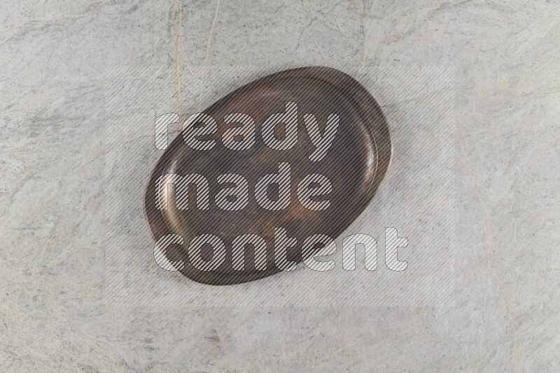 A vintage metal tray on grey marble background