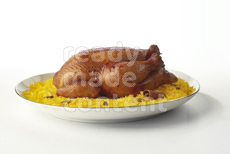 yellow  basmati Rice with kabsa chicken pieces on a white plate with a silver rim direct on white background