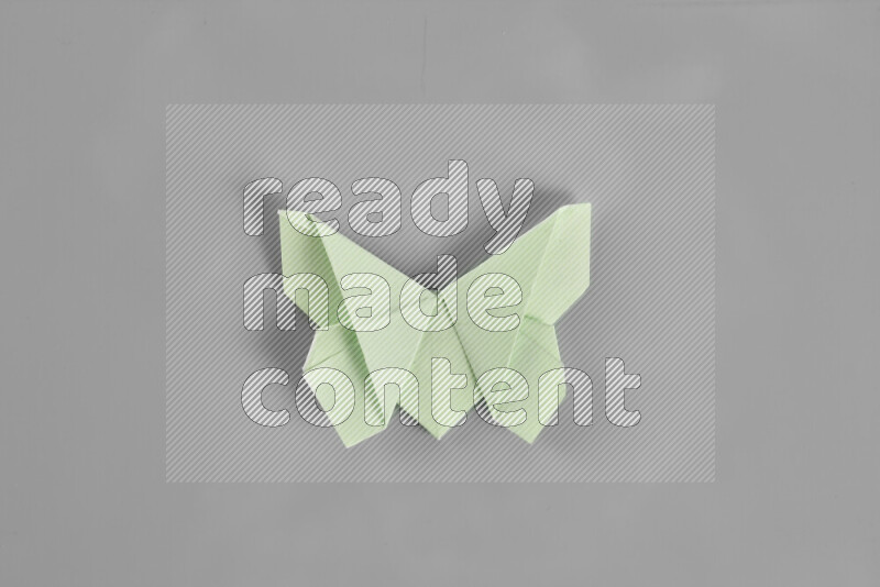 Origami butterfly on grey background