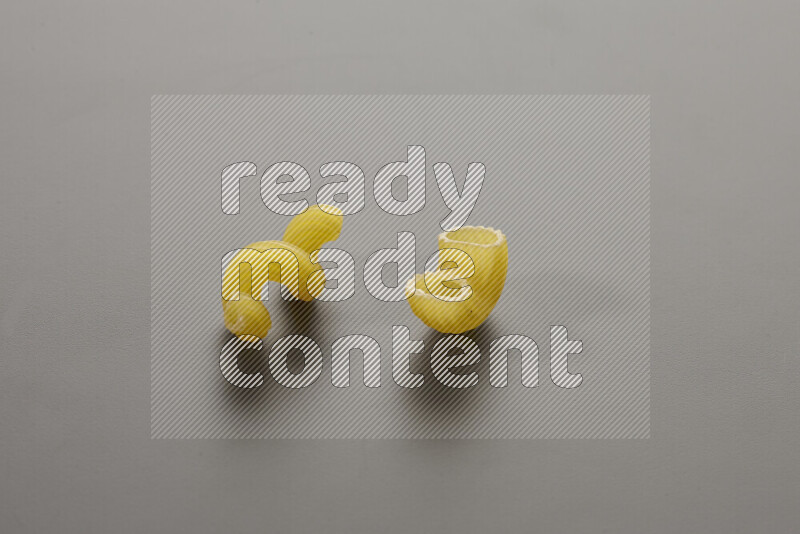 Twist pasta with other types of pasta on grey background