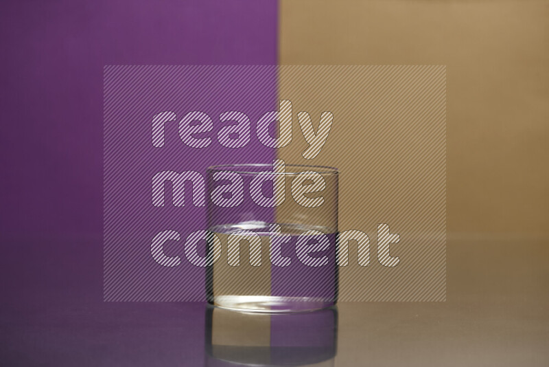 The image features a clear glassware filled with water, set against purple and beige background