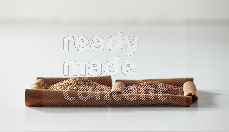 2 squares of cinnamon sticks full of mustard seeds and garden cress on white flooring