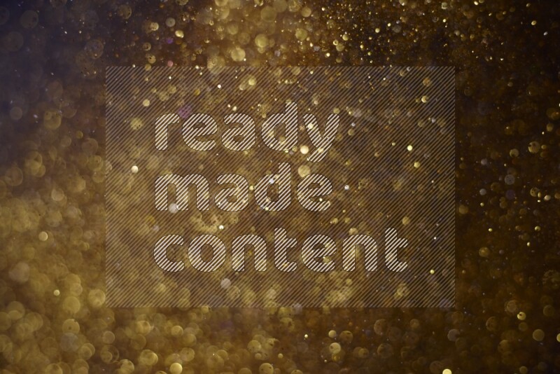 Gold glitter powder isolated on black background