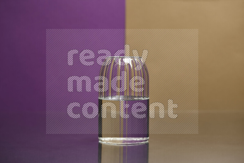 The image features a clear glassware filled with water, set against purple and beige background