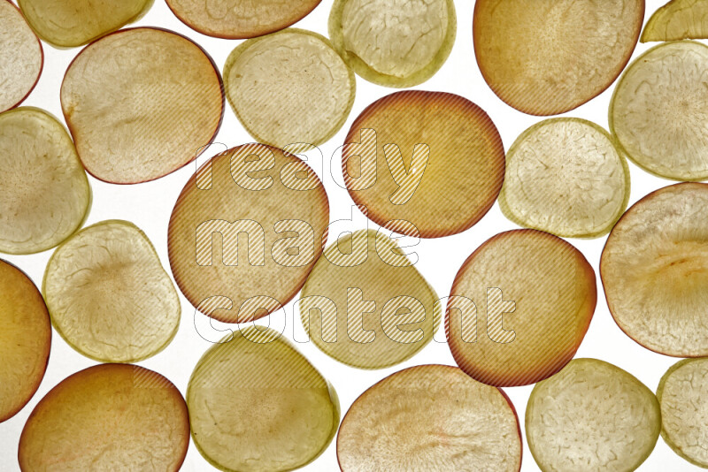 Plum slices on illuminated white background